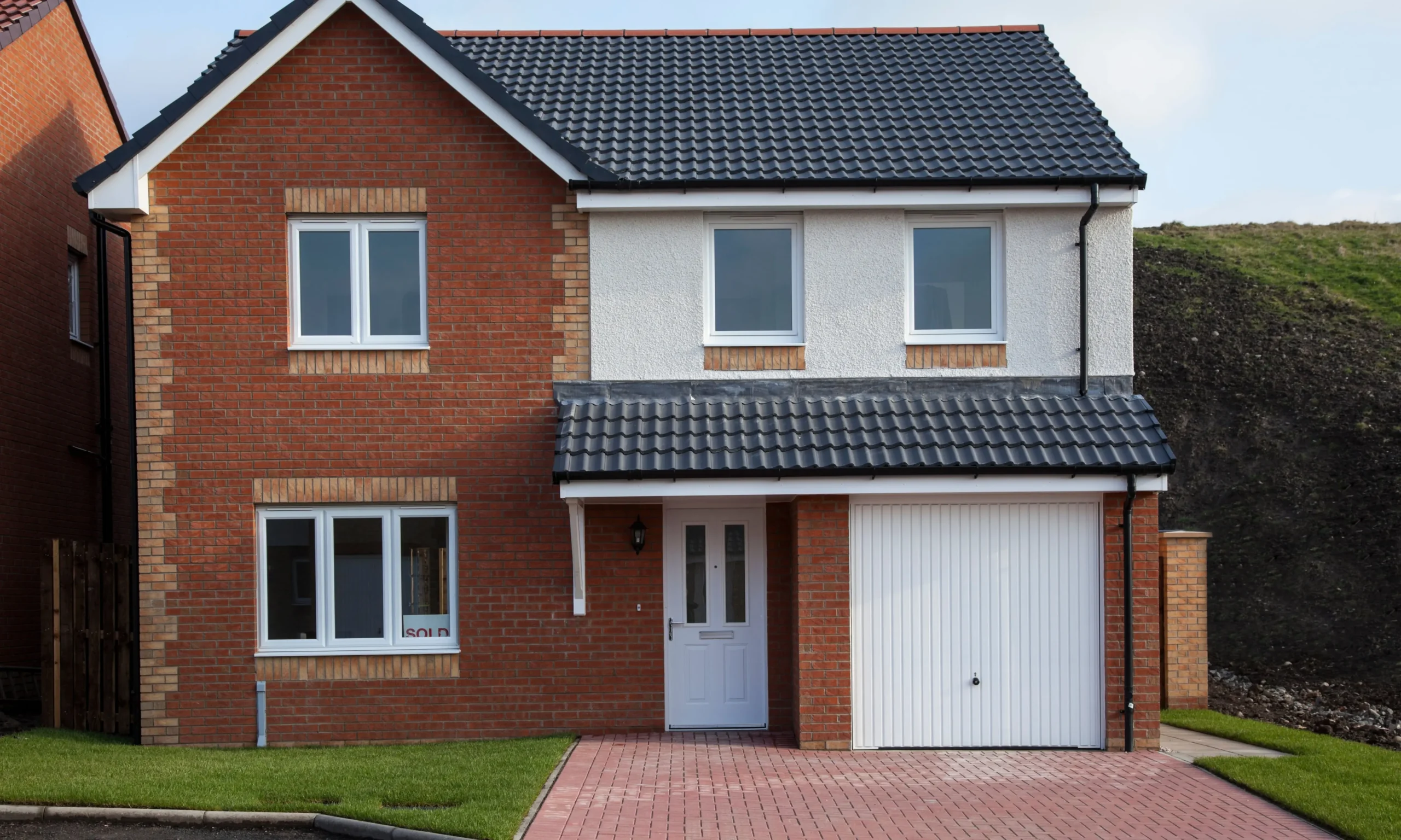 Detached UK house with completed external wall insulation and silicone render finish