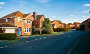 Row of detached brick houses in the UK ideal for external solid wall insulation to improve thermal efficiency and reduce heating costs