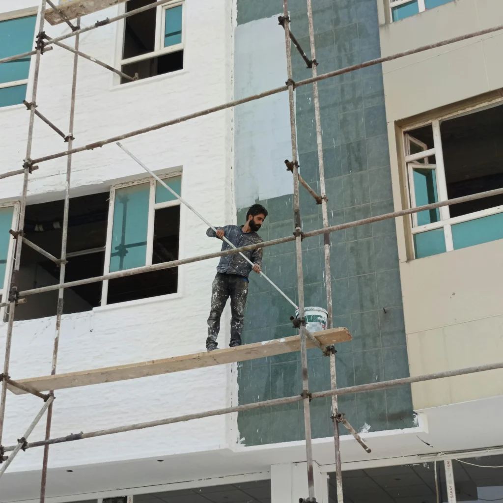 k rend paint application on silicone render facade during exterior painting works
